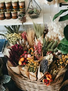 a basket filled with lots of different types of flowers