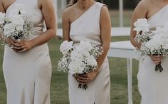 four bridesmaids in white dresses holding bouquets