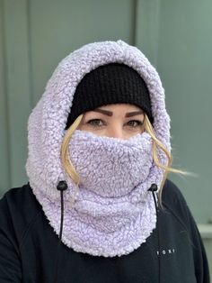 Balaclava - Sherpa FITS OVER HELMET! Fits over most adult helmets as well as over beanies  Hood made with Sherpa fleece Stay warm in style!  Wear with hood up or down, and face mask up or down  Pull strings with cord stops to stay tight  Adult size, fits most!  Beanie hat not included  100% polyester   Dry clean only!  *Pattern placement may vary Winter Solid Balaclava With Fleece Lining, Winter Outdoor Bonnet - One Size Fits Most, Winter Sports Balaclava, Windproof Beanie Balaclava For Winter, Casual Balaclava With Fleece Lining For Winter, Warm Balaclava For Winter Outdoor Wear, Winter Hooded Balaclava One Size Fits Most, Warm Balaclava For Outdoor Winter Wear, Casual Winter Balaclava With Fleece Lining