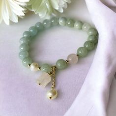 Introducing our Chinese vintage style beaded bracelet that's made in matte green color quartz beads. the charm is in the shape of dangly lily of the valley. It is a great calming accessory to keep for yourself or to gift for your friends! Jade Beaded Bracelets With Gemstone Beads As Gift, Jade Gemstone Beaded Bracelets As Gift, Small Beaded Dainty Jewelry Gift, Dainty 8mm Beads Jewelry Gift, Dainty 8mm Bead Jewelry Gift, Elegant Jade Beaded Bracelets For Gift, Elegant Green Beaded Charm Bracelet, Elegant 8mm Beads Jewelry For Mother's Day, Elegant Jewelry With 8mm Beads For Mother's Day