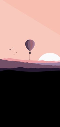 a hot air balloon flying in the sky over an ocean at sunset with birds flying around