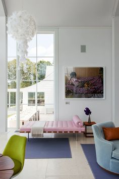 an instagram photo of a living room with pink and blue furniture