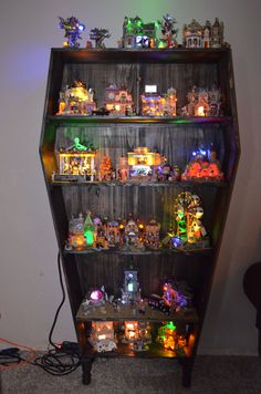 a book shelf filled with lots of toy figurines on top of wooden shelves