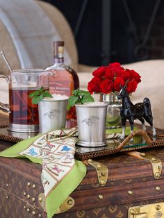 a tray with two cups and a horse figurine sitting on top of it