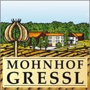 the sign for mohnoff gressl is in front of some houses and trees