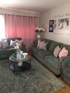 a living room filled with furniture and pink curtains