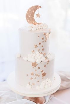 a white cake with gold stars and a moon on top