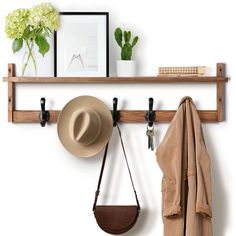 a hat, coat rack and purse hanging on a wall