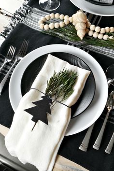 a place setting with black and white plates