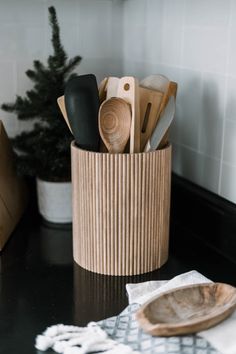 kitchen utensils in a wooden holder on a counter