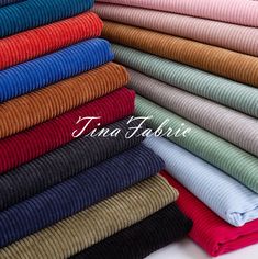 many different colored sweaters stacked together on top of each other, with the word trina fabrics written above them