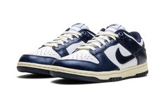 The Women’s Nike Dunk Low PRM "Vintage Navy" is a women’s-exclusive colorway of the retro basketball shoe with a vintage-inspired design.  The “Vintage Navy” honors the Dunk’s storied history as a mid-1980s college basketball team shoe with its aged, vintage look.  The cream rubber midsole mimics the oxidation process rubber undergoes after years of use.  Up top, the shoe features a white leather base with Vintage Navy leather overlays and Swoosh branding that have a slight sheen and textured fi Sb Dunks, Retro Basketball Shoes, Retro Basketball, Navy Shoes, Basketball Team, Stadium Goods, Navy Leather, College Basketball, Basketball Teams