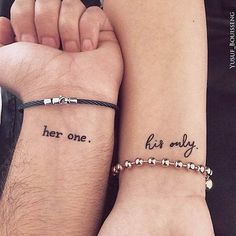 two people with matching tattoos on their arms, one is holding the other's hand