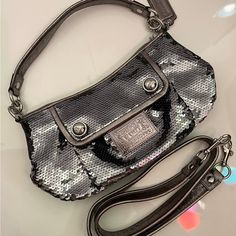 Coach Poppy Limited Edition Silver Sequin Groovy Crossbody Bag #15381 - Style: Crossbody/Satchel - Material: Graphite Grey Silver Sequins With Leather Trim Silver Hardware - Closure: Zip-Top - Inside Zip And Multifunction Pockets - Exterior Front Pocket Kept Closed With Hidden Magnetic Snap - Fabric Lining. - Approx. 11" (L) X 6.75" (H) X 4" (W) - 100% Authentic New Without Tags Luxury Coach Bag For Party, Luxury Coach Party Bag, Luxury Coach Party Bags, Coach Evening Crossbody Bag, Chic Coach Party Bag, Chic Party Bags By Coach, Elegant Coach Shoulder Bag For Party, Crossbody Satchel, Coach Poppy