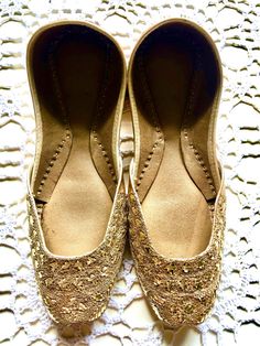 Hand crafted & Hand embroidered  Leather shoes in a beautiful bronze color embellished with rich gold thread work - often called Zardozi Zardozi comes from two Persian words: zar, meaning 'gold', and dozi, meaning 'work'. Zardozi embroidery is a type of metal embroidery. Zardozi embroidery work involves making elaborate designs using gold threads .  Khussa is a style of South Asian handcrafted footwear produced in Punjab Pakistan.Khussa are made by artisans by hand. The uppers are made of one pi Festive Embroidered Slip-on Flats, Embroidered Flats For Diwali Festive Occasion, Festive Embroidered Flats For Diwali, Traditional Party Flats With Round Toe, Handwork Flats For Festivals, Handwork Flats For Festive Occasions, Handwork Flats For Festive Occasions And Festivals, Festive Mirror Work Closed Toe Flats, Traditional Embellished Party Flats