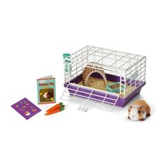 a toy hamster is laying on the ground next to it's cage and book