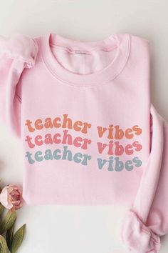 TEACHER VIBES Graphic Sweatshirt** PLUS SIZE AVAILABLE: 10876X-SS-PLUS **- Premium 8 oz., 50/50 cotton/ polyester- Air jet yarn for softer feel and reduced pilling- Classic Fit- Unisex Sizing- Designed and printed in Los Angeles Style: CASUAL Print / Pattern: TEACHER VIBES Silhouette: SWEATSHIRT Fit: UNISEX Neck Line: CREW Sleeve: LONG Fabric Contents: 50% COTTON, 50% POLYESTER Stretch fabric Non-sheer fabric Care Instructions: MACHINE WASH COLDLINE DRYSize Measurement (inch): S: 20.0 (Bust), nu Basic Pink T-shirt For Fall, Pink Slogan T-shirt For Loungewear, Pink Athleisure Sweatshirt For Leisure, Pink Relaxed Fit Top For Leisure, Pink Letter Print Tops For Leisure, Leisure Pink Tops With Letter Print, Pink Long Sleeve T-shirt With Text Print, Trendy Pink Cotton Sweatshirt, Sporty Soft-washed Pink Tops