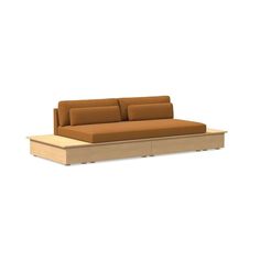 a brown couch sitting on top of a wooden table