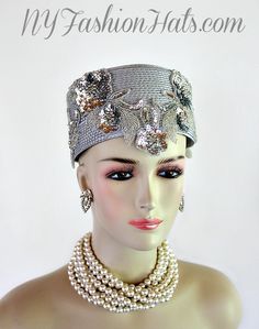 Women's Silver Grey Metallic Silver Pillbox Fashion Designer Haute Couture Hat Headpiece. Metallic Silver Glass Beaded Sequin Pearl Floral Appliques Are Placed On This 1920's Flapper And Art Deco Era Hat. This Formal Hat Can Be Worn In Different Positions. This ladies bespoke formal hat is appropriate to wear for the Kentucky Derby, Melbourne Cup, Royal Ascot, horse races, horse racing, Church, weddings, and special occasion. This lovely hat is also suited for mother of the bride or a bride. This Unique Hat Will Make A Fashion Statement. This Special Occasion Hat Is Custom Made And Designed By NY Fashion Hats Millinery, www.nyfashionhats.com, Dress Hats For Women, www.dresshatsforwomen.com

Measurements: Crown Measures 22.5". Standard Sized For Most Women - Condition New - Custom Made

Mat Special Occasion Hats, Bridesmaid Headpiece, Mother Of The Bride Hats, Formal Hat, Bespoke Hats, Bridal Art, Preakness Stakes, 1920's Flapper, Church Weddings