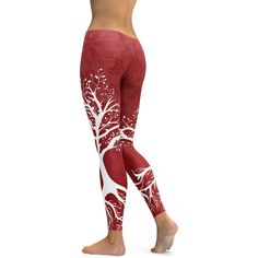 a woman in red and white patterned leggings with trees on it, back view