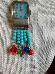 "~ I made this set and fell in love with it. It is one of my favorite pieces. It is made of an vintage (man's) watch face (non working). Inside the watch is patina, which is a green color and was the inspiration in my color choices. I added clear seed beads and a beautiful art glass bead at the top. All the beads are vintage and glass. On the bottom of the necklace I hung several turquoise colored beads and a different color and kind off each section. The chain is also vintage, maybe from the 80 Teal Glass, Vintage Picture Frames, Metal Ball, Red Bead, Turquoise Color, Necklace Earring Set, Ball Chain, Necklace Earrings, Initial Necklace