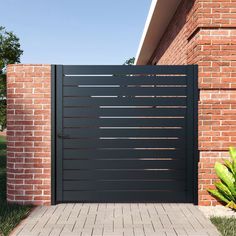 a modern gate in front of a brick house