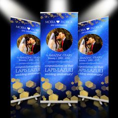 three roll - up banners for an event with the image of a bride and groom kissing