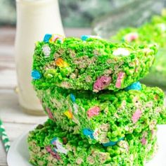 rice krispy treats stacked on top of each other with a glass of milk in the background