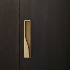 an open door with a wooden handle on it's left side and a black background