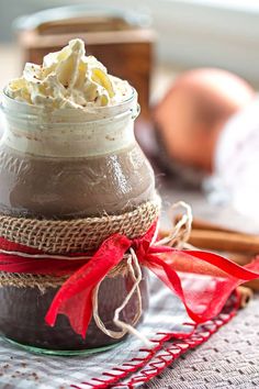 a jar filled with whipped cream sitting on top of a table