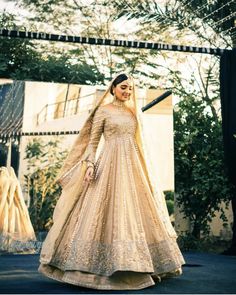 a woman in a long dress standing outside