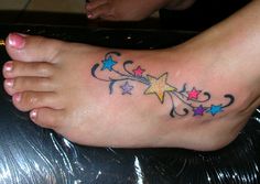 a woman's foot with stars and swirls on it