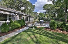 a house with landscaping and trees in the front yard