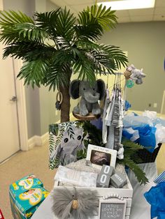 a baby's gift basket with an elephant, giraffe and other items