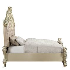 a white bed with an ornate headboard and foot board is shown against a white background