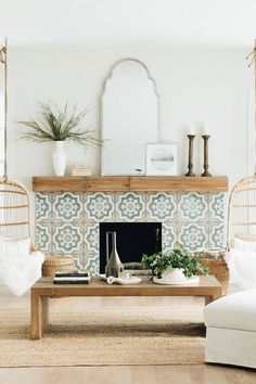 a living room filled with furniture and a fire place in front of a wall mounted mirror