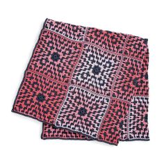 two red and black patterned napkins sitting on top of each other