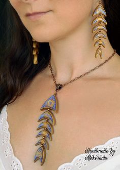 a woman wearing a necklace with gold and blue designs on it's neckline