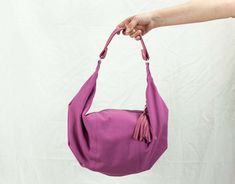 "This is the mini version of the Kallia bag. For those who aren't used to carrying large purses, this is the ideal size. Still roomy enough to carry your daily essentials inside but in a smaller size. This slouch bag was made using an antique fuchsia cotton canvas and genuine leather for the handle and zipper pulls. All the leather parts can be removed from the bag so it is easier to clean it , in case it gets dirty. Not to mention that you can order extra handles and zipper pulls and interchange the colors depending on mood or outfit. You can find the extra handles here http://etsy.me/1qd8AY2 You can even pair it with a matching cosmetic case, or customize one and have everything you need always at hand and tidy http://etsy.me/SpsWkT Inside the bag, there is a cotton fabric used for the l Pink Tote Hobo Bag For Errands, Pink Handheld Hobo Bag With Removable Pouch, Pink Handheld Hobo Bag For Everyday, Everyday Pink Handheld Hobo Bag, Pink Hobo Bag For Daily Use, Pink Satchel Hobo Bag For Errands, Pink Handheld Hobo Bag For Travel, Versatile Pink Hobo Bag, Pink Everyday Hobo Bag Shaped As Satchel