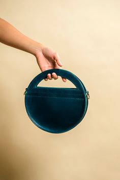 This is my newest design called the Hali Bag. It gets its name from the Greek meaning "the sea". Its made from Buttero Veg Tan Leather by Conceria Walpier, some of the finest Italian leather produced. It offers two ways of wear, from the unique half moon handle or a detachable and adjustable strap. Its roughly 10 x 9 1/2 x 2 and has a strap thats over 50 inches long, giving you lots of room to wear it as a crossbody or over the shoulder. Each one is crafted by hand from start to finish, using Ri Blue Leather Bags With Round Handle, Blue Leather Bag With Round Handle, Leather Bags With Round Handle For Gifts, Unique Bags Design, Greek Meaning, Unique Handbags, Luxury Purses, Veg Tan Leather, Round Leather