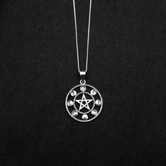 "Real 925 Sterling Silver Moon Phases Pentacle Charm Necklace This simple yet elegant necklace features a sterling silver Moon Phases Pentacle on a Dainty Sterling silver 18\" cable chain. Charm Measures 40 x 29mm Jewelry will come in a gift box * Please read shop policy before placing an order * *JEWELRY CARE* Sterling Silver will tarnish over time, but to help keep your jewelry looking beautiful - Clean with a soft dry cloth after wear and store inside an airtight bag or container. Remember to Mystical Moon Charm Sterling Silver Necklace, Mystical Sterling Silver Necklace With Moon Charm, Symbolic Silver Moon Phase Necklace, Symbolic Silver Necklace With Moon Phase, Symbolic Sterling Silver Round Charm Necklaces, Silver Moon Shaped Symbolic Necklace, Silver Symbolic Charm Necklaces, Mystical Silver Round Jewelry, Silver Symbolic Round Charm Necklaces