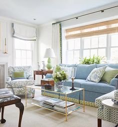 a living room filled with furniture and a fire place in front of a painting on the wall