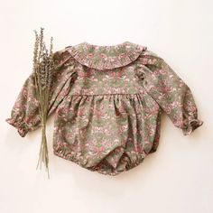 Made from Organic Cotton: An eco-friendly, breathable, and hypoallergenic fabric that’s gentle on delicate skin. Care Instructions: Machine wash on a gentle cycle, tumble dry on low. A Thoughtful Gift: Ideal for birthdays, holidays, or any day you want to make extra special for the little one in your life. Spring Long Sleeve Bubble Romper For Playtime, Spring Playtime Long Sleeve Bubble Romper, Spring Playtime Bubble Romper With Long Sleeves, Long Sleeve Bubble Romper For Spring Playwear, Cotton Ruffle Onesie For Playwear, Cotton Onesie With Ruffles For Playwear, Green Bubble Romper With Ruffles For Playtime, Green Ruffled Bubble Romper For Playtime, Fitted Green Bubble Romper For Play