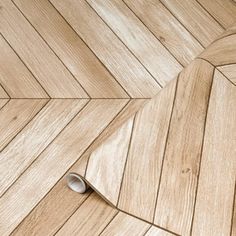 a wooden floor that is laying on top of wood planks with a hole in the middle