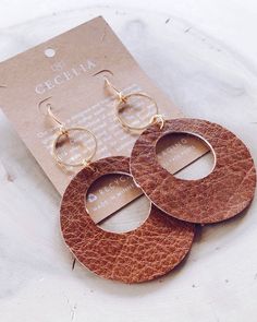 Our Viti Earring collection is handmade in Minnesota. You plant one tree with each purchase! These lightweight earrings are made with genuine or vegan leather, a gold plated hoop and a nickel free ear wire. 3" L x 2" W. T Everyday Handmade Brown Hoop Earrings, Handmade Brown Hoop Earrings For Everyday Wear, Everyday Brown Hoop Earrings With Ear Wire, Minimalist Brown Hoop Earrings For Everyday, Trendy Brown Jewelry For Everyday Use, Trendy Brown Hoop Earrings For Everyday, Chic Brown Earrings For Everyday Wear, Trendy Faux Leather Jewelry For Everyday, Chic Brown Everyday Earrings