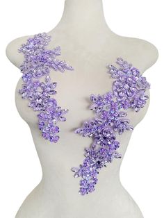 a white mannequin with purple flowers on it