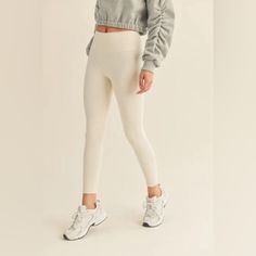 These Cream High-Rise Leggings Are A Must Have Closet Staple! Quick-Drying, Breathable And Weightless Fabric With A Butter Soft Feel And Four-Way Stretch. The Color Is A Must For Spring And Summer! Details: 75% Nylon, 25% Spandex Color Is Cannoli Cream Butter Soft Feel Wide High-Rise Waistband Inseam: S- 26" , M- 26.25" , L- 26.50" *Model's Measurements: Height 5'8.5" | Bust 34" | Waist 25" | Hips 35.5" Casual High Rise Compressive Pants, Casual High-cut Tight Leggings, High Waist Leggings With Ribbed Waistband, Cream Stretch Bottoms With Elastic Waistband, Cream Bottoms With Elastic Stretch Waistband, Cream Stretch Long Pants, Beige Compression Athleisure Bottoms, High Waist Stretch Cream Bottoms, High Waist Cream Stretch Bottoms