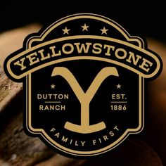 the yellow stone family first logo is shown in gold, black and white with stars on it