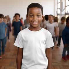 a young boy standing in front of a room full of children wearing t - shirts