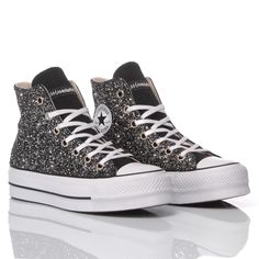 Converse All Star Platform Glitter Black, the women's trainer has had a makeover. Covered in black glitter on both the outer and inner sides, because glitter is never enough, your feet deserve to sparkle to the max. The Converse All Star Platform Glitter Black comes with its original white laces. For extra comfort, we offer you our heel lift insole, which, in addition to comfort, gives you a few extra inches and an immediate figure-enhancing boost. Black Glitter Lace-up Sneakers, High-top Glitter Sneakers For Party, Glitter High-top Party Sneakers, Black Glitter Party Sneakers, Black Party Sneakers With Glitter Accents, Black Glitter Sneakers With Round Toe, Black Glitter Round Toe Sneakers, Casual Black Glitter Sneakers, High-top Glitter Print Party Sneakers